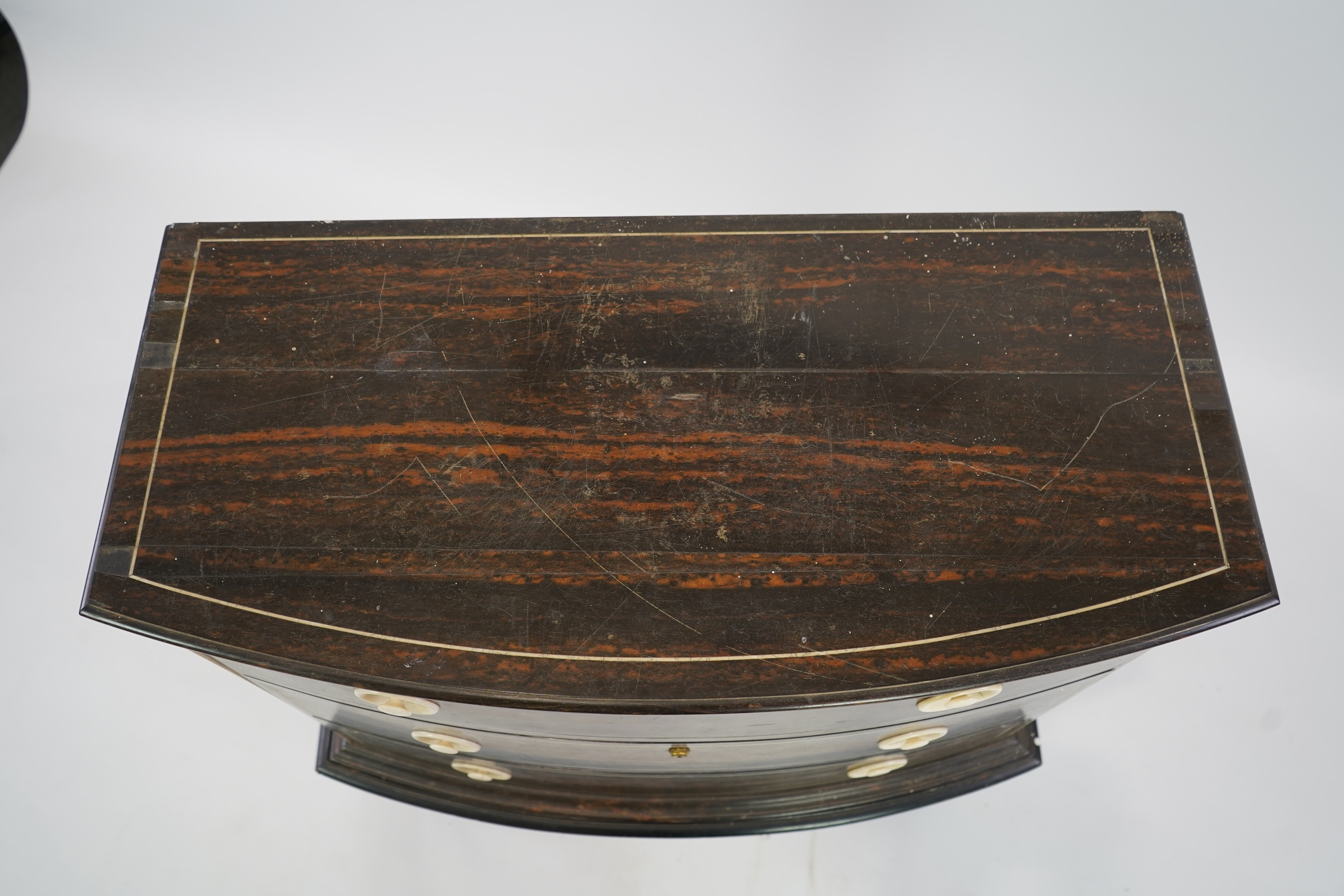 An early 20th century ivory mounted coromandel three drawer bowfront chest, stamped Callow of Mount Street, London